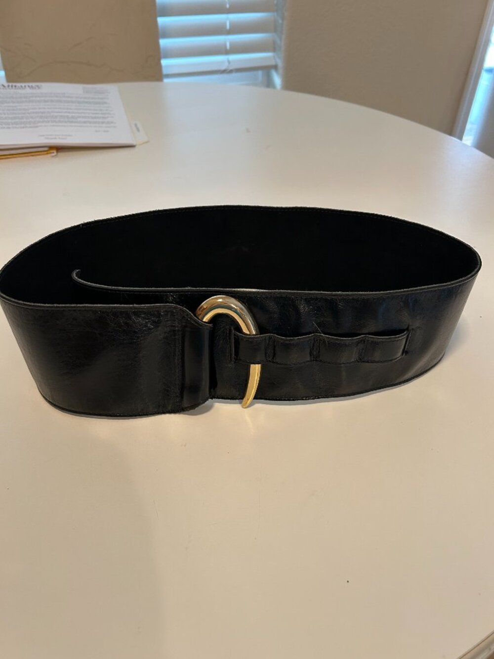 Vintage Wide Black Belt featuring a gold-tone metal hook-style buckle